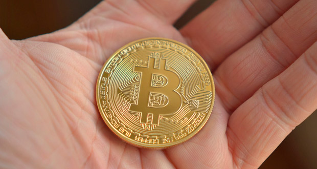 Hand holding a Bitcoin