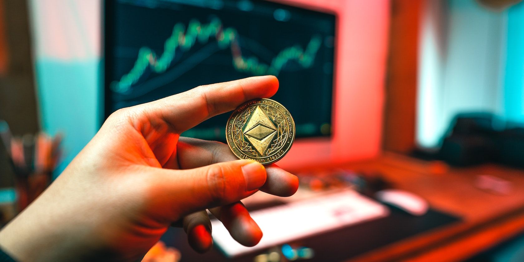 Hand holding an Ethereum coin